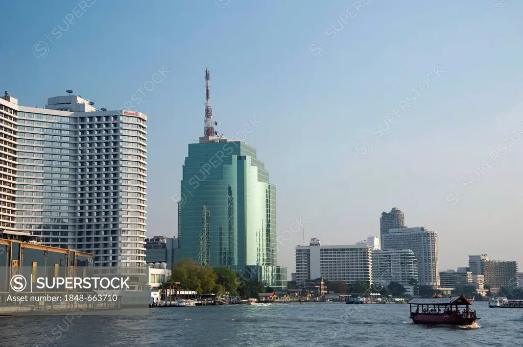 Boat on the Chao Phraya River with views of the Bangkok skyline, Thailand, Asia