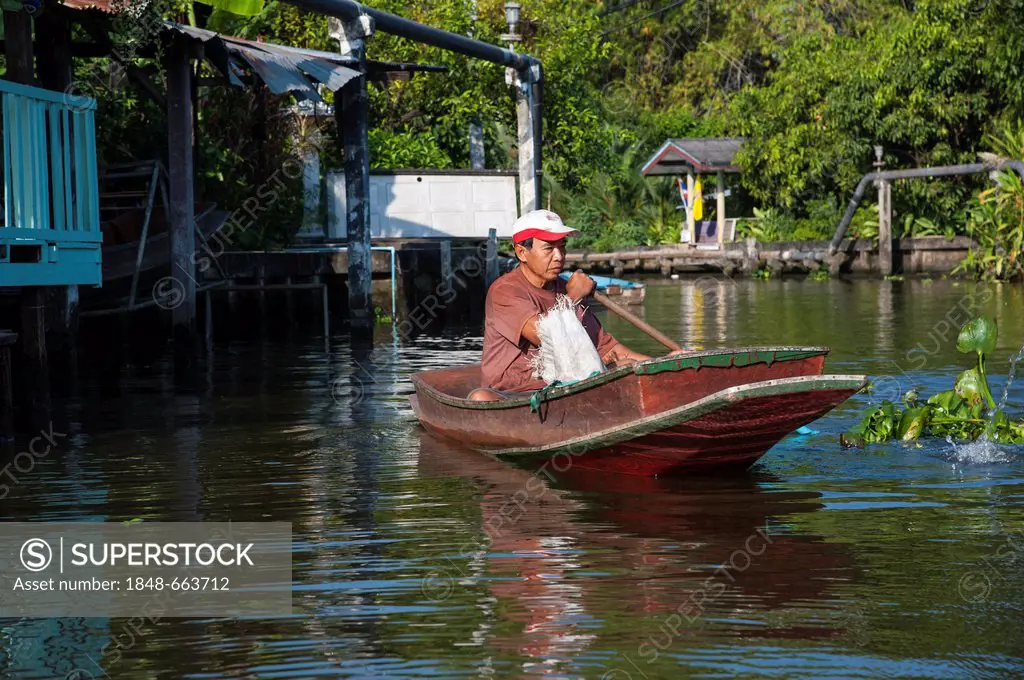 Man in a boat, Khlong or Klong, canal, Bangkok, Thailand, Asia