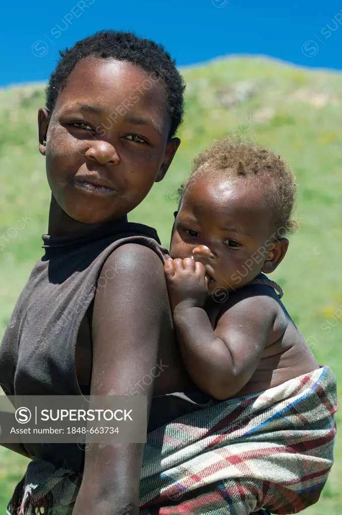 Woman carrying child on her back, Highlands, Kingdom of Lesotho, Africa