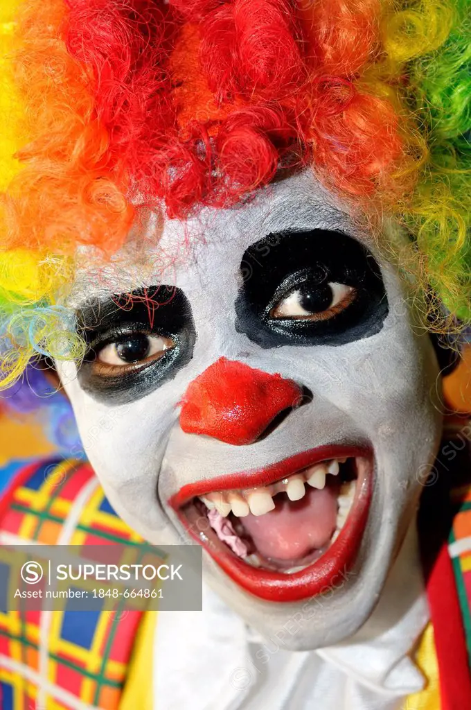 Laughing boy, dressed up as a clown, Port-au-Prince, Haiti, Caribbean, Central America