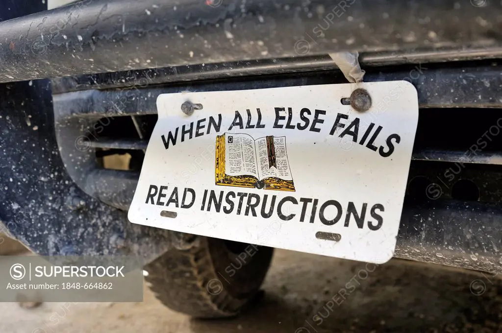 Sign with bible and lettering When all else fails - read instructions as a license plate on a car, Haiti, Caribbean, Central America
