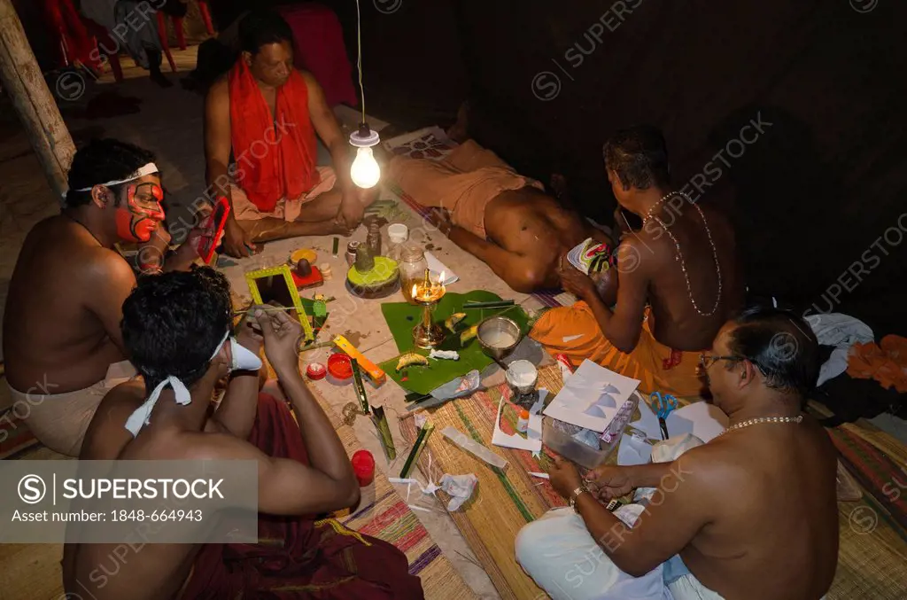 Spiritual ceremony of applying the make-up of the Kathakali dancers, Perattil, Kerala, India, Asia