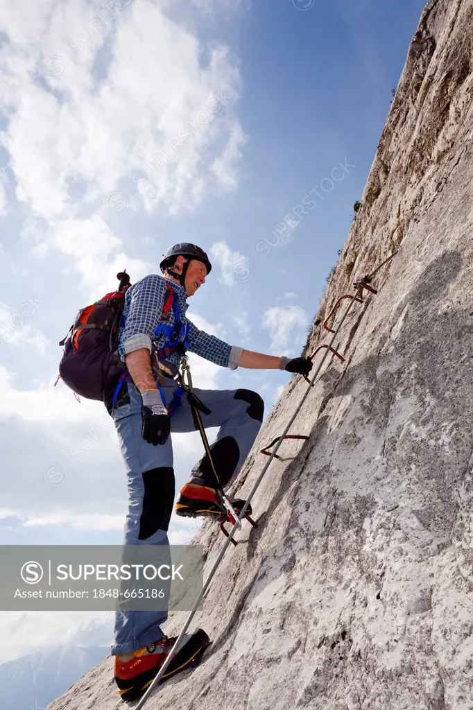 Climber on the Che Guevara fixed rope route on Mt. Monte Casale in the Sarca Valley, Lake Garda region, Trentino, Italy, Europe