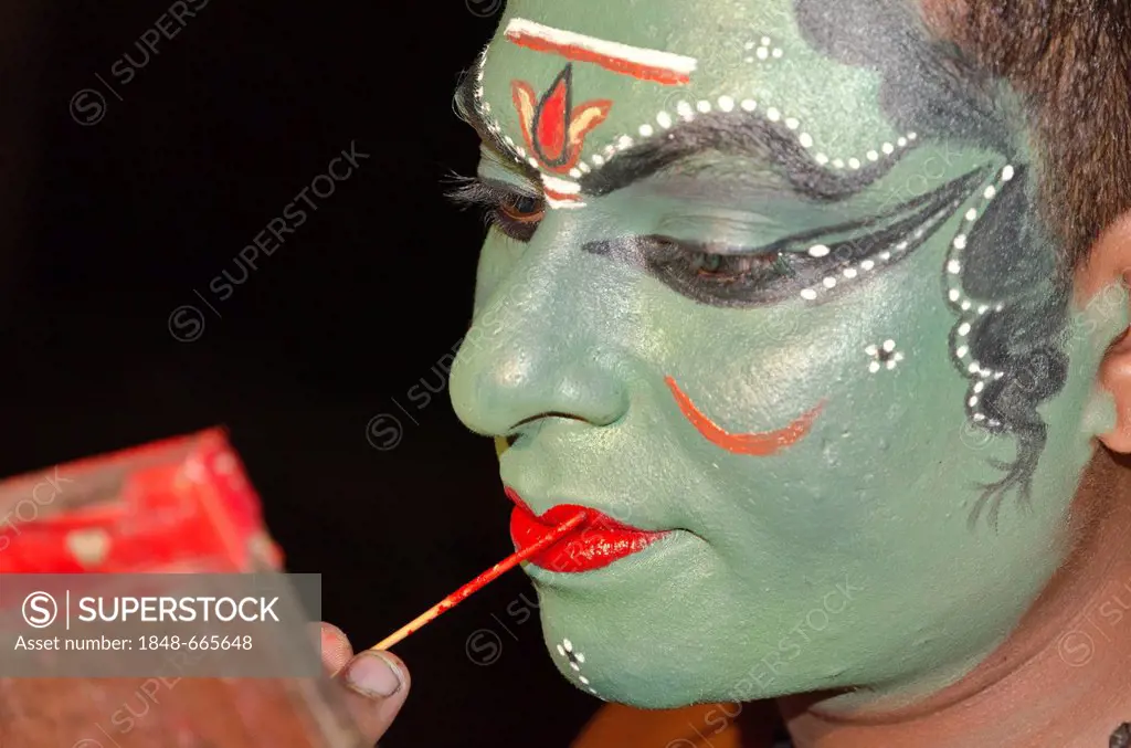 The make-up of the Kathakali character Kathalastri is being applied, Perattil, Kerala, India, Asia