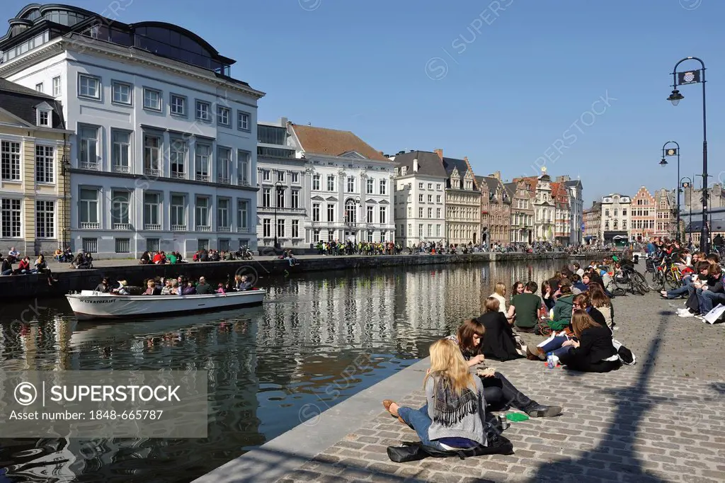 People sitting along the banks of the Lys river on a sunny day, Ghent, Flanders, Belgium, Europe