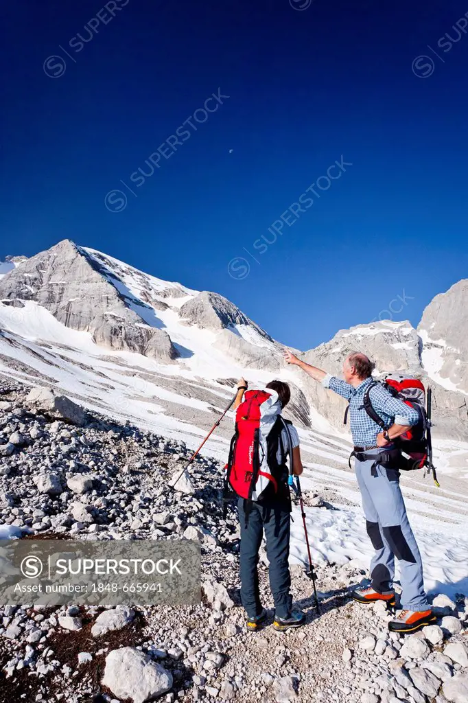 Mountaineers climbing Marmolada mountain, Dolomites, Westgrat fixed rope route, Marmolada mountain at the back, province of Trento, Italy, Europe