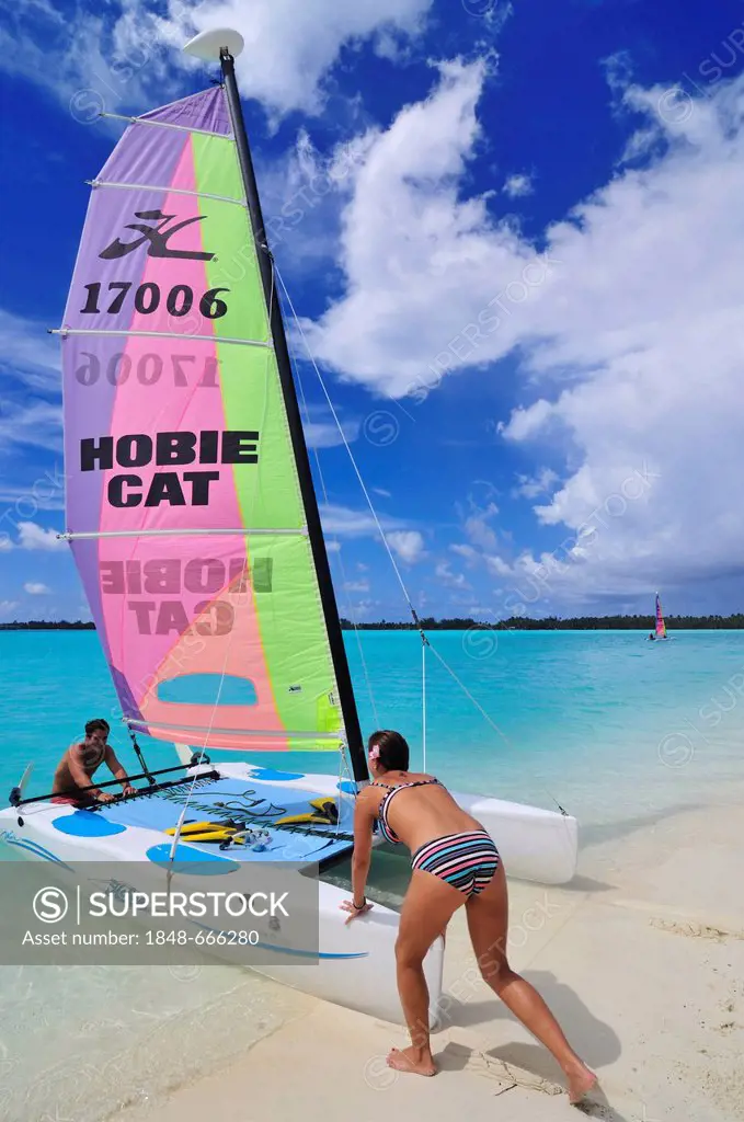 Tourists sliding catamaran into the sea, St. Regis Bora Bora Resort, Bora Bora, Leeward Islands, Society Islands, French Polynesia, Pacific Ocean