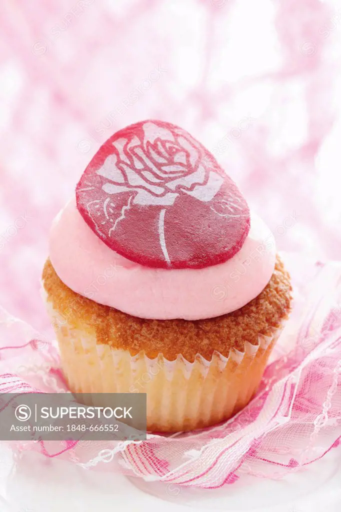 Cupcake with pink butter cream and marzipan rose