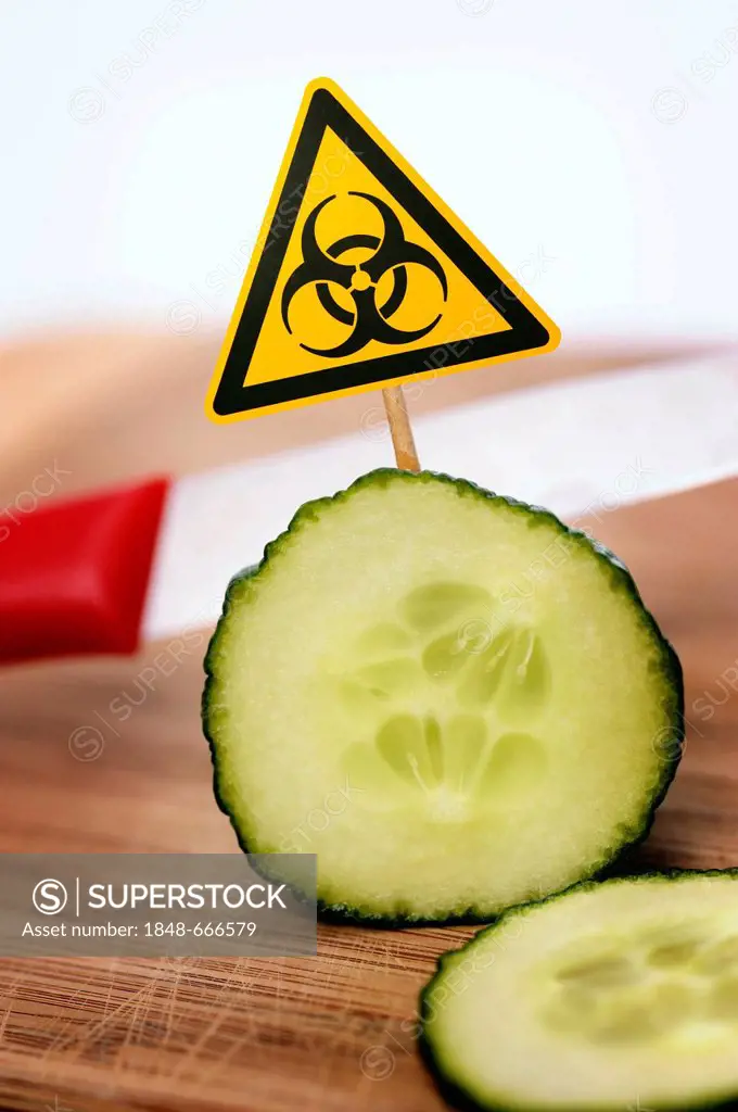 Sliced cucumber with bio-hazard symbol, symbolic image for EHEC pathogens