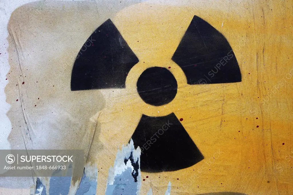 Street art, symbol for radioactivity and nuclear power, sprayed on a wall