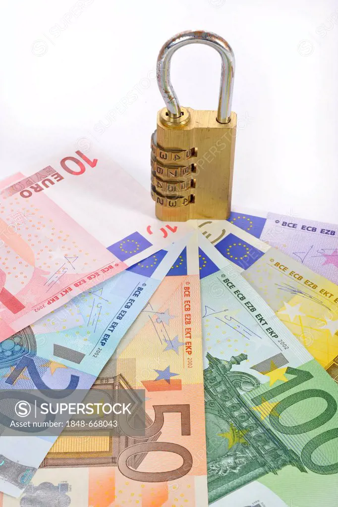 Combination lock on euro banknotes, symbolic image of monetary security
