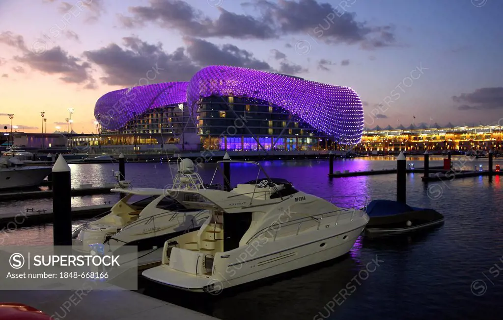 Yas Hotel on Yas Island, futuristic luxury hotel in the middle of the Formula 1 race track of Abu Dhabi at dusk, United Arab Emirates, Middle East, As...