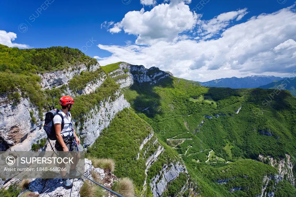 Climber near the Gerardo Sega fixed rope route on Mounte Baldo mountain above Avio, Lake Garda region, province of Trento, Italy, Europe