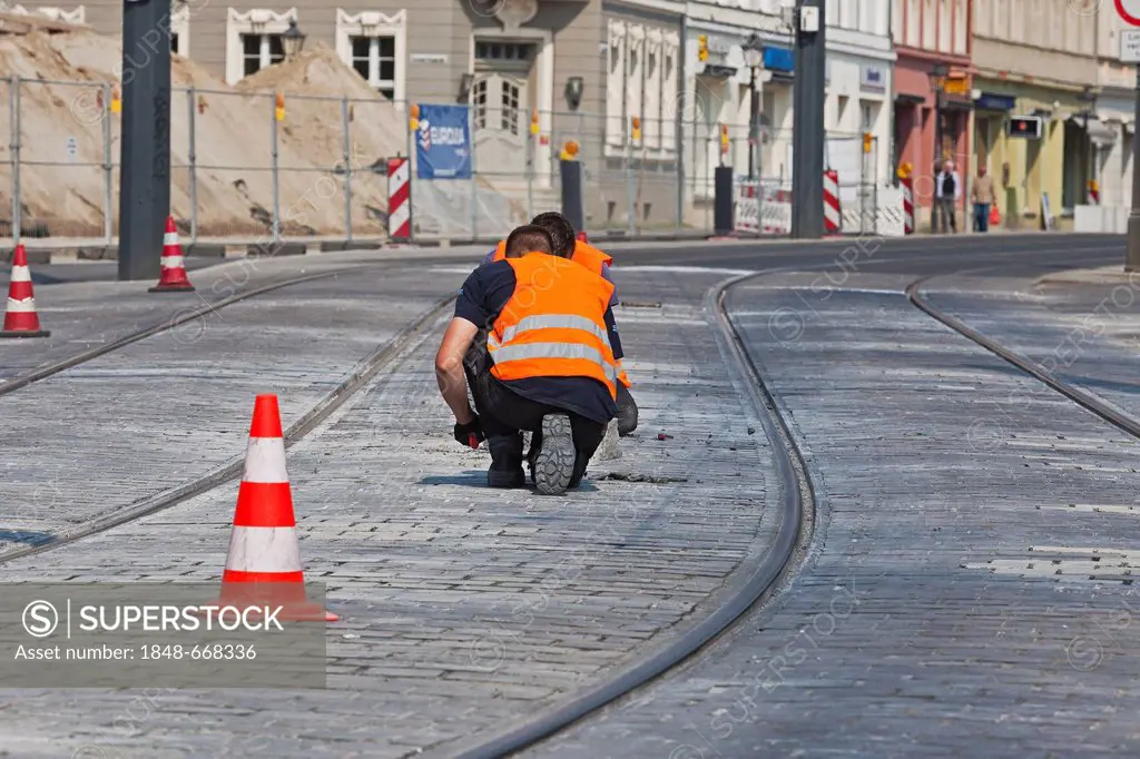 Construction worker renewing the track bed, Potsdam, Brandenburg, Germany, Europe