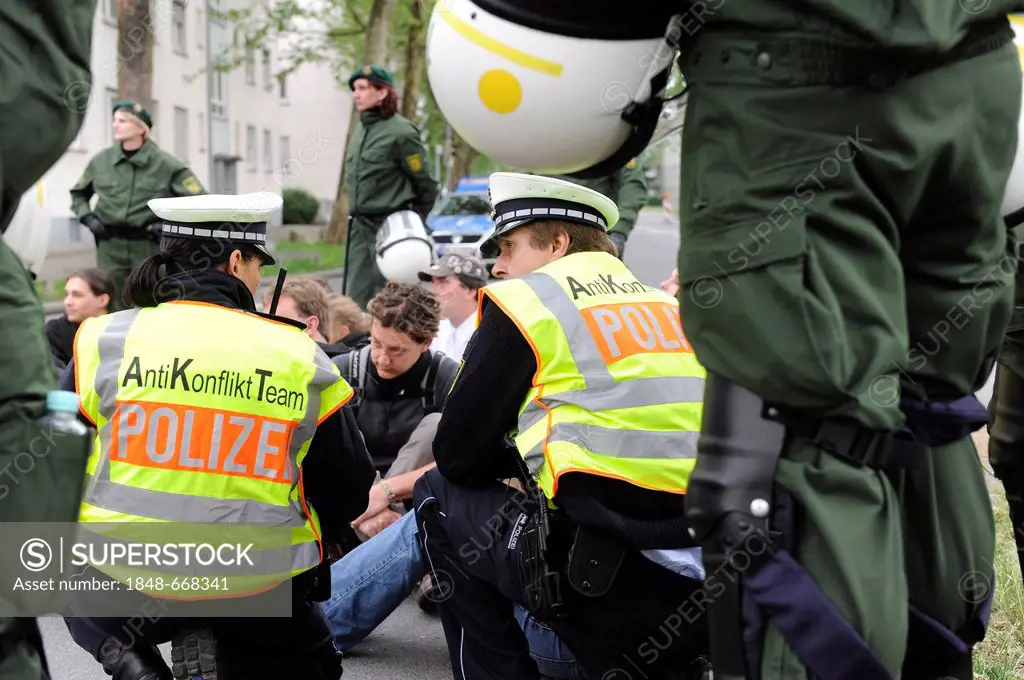 1st May rally, two police officers of the anti-conflict team in discussions with leftist protesters during a blockade, Heilbronn, Baden-Wuerttemberg, ...