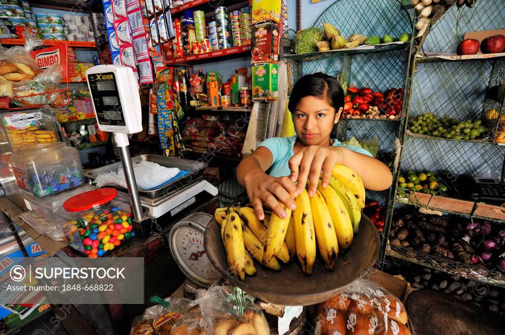Child labour, girl, 14, working in the shop of her parents, slums of Amauta, Lima, Peru, South America