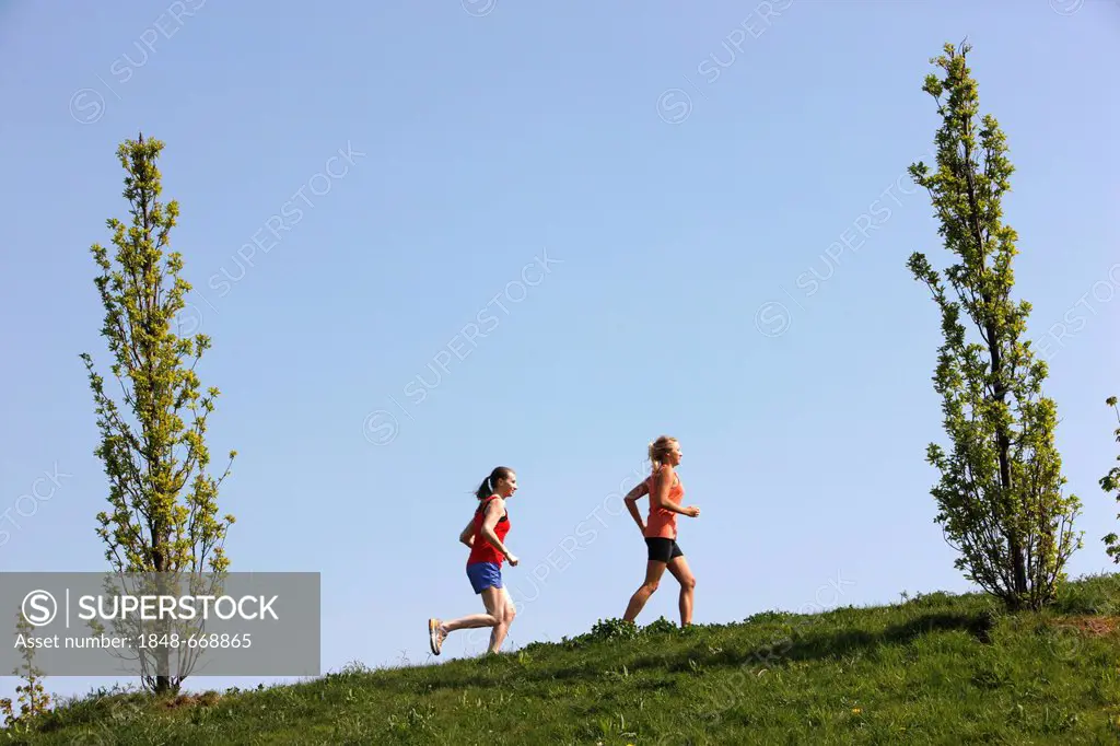 Two recreational runners, young women, 25-30 years, jogging