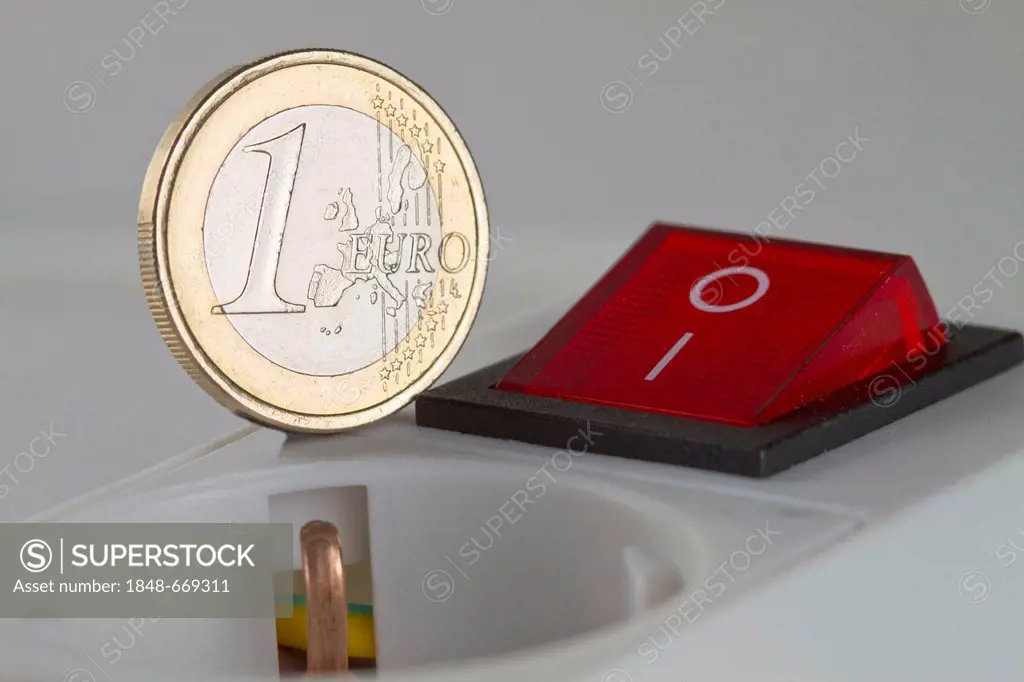 One-euro-coin on a multi-plug connector with a switch, symbolic image for electricity rates