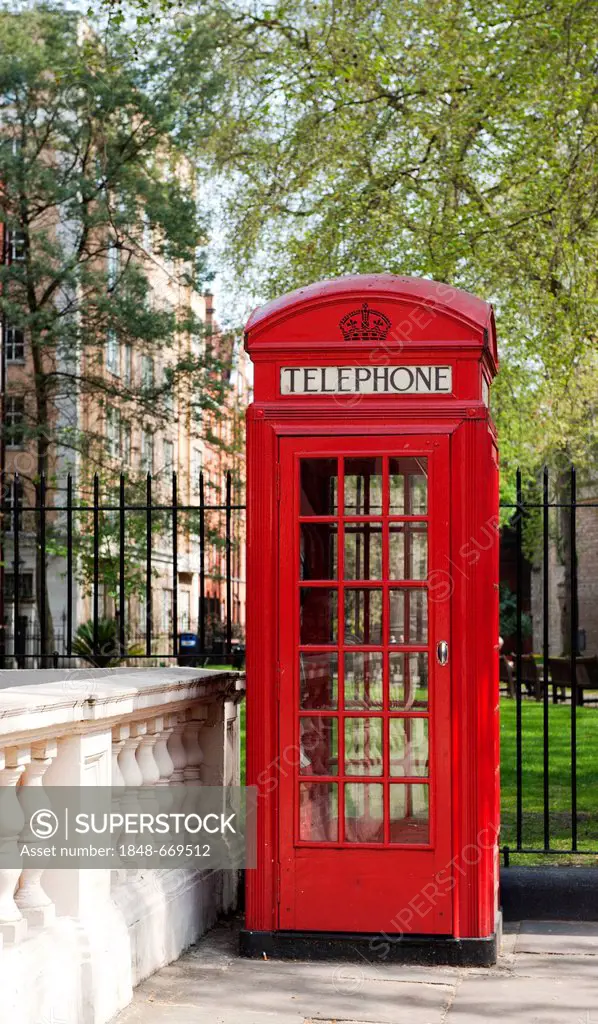 Red telephone booth in Mayfair, Mount Street Gardens, London, England, United Kingdom, Europe