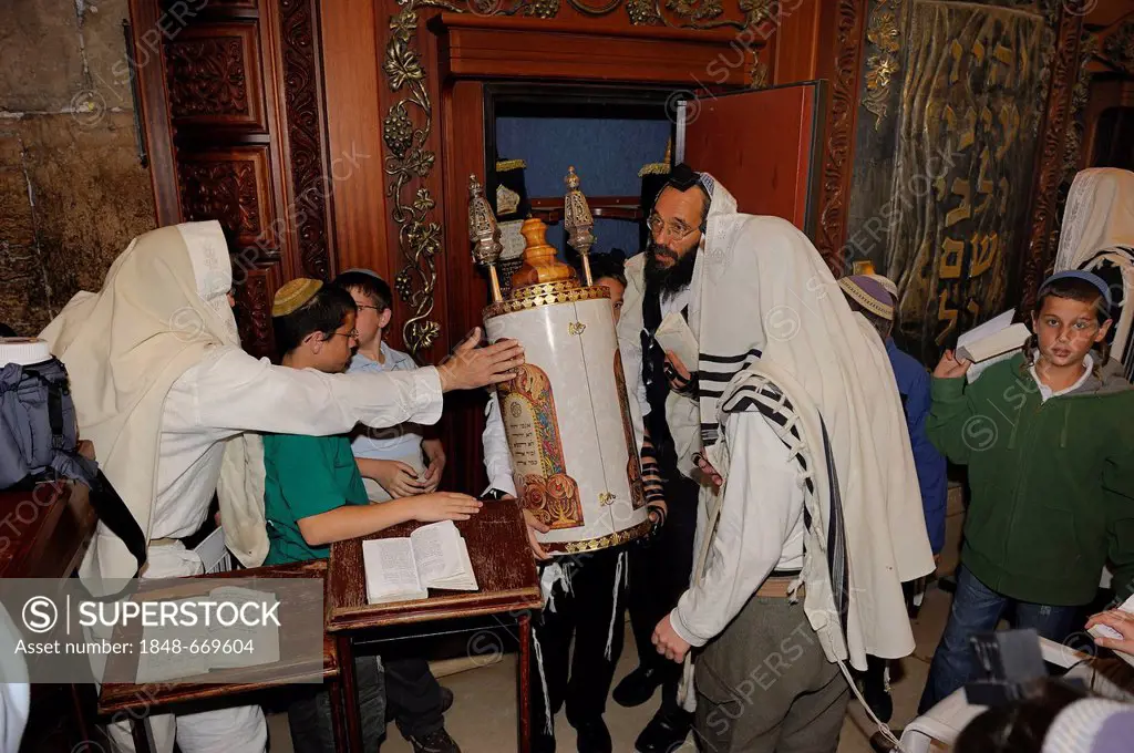 Bar Mitzvar, Jewish coming of age ritual, the Torah scroll is returned to the Torah cabinet, its back resting against the Western Wall or Wailing Wall...