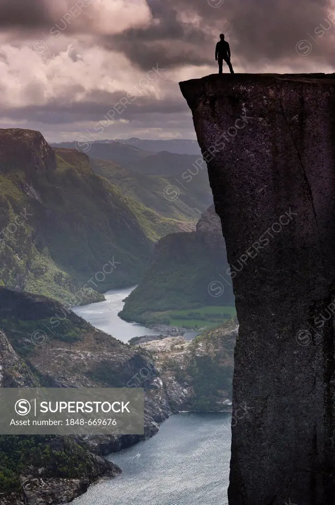 Man standing on Pulpit Rock, also known as Preikestolen, Lysefjorden fjord at the back, Jorpeland, Rogaland, Norway, Scandinavia, Northern Europe