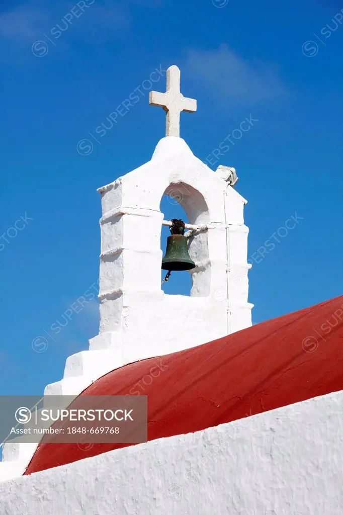 Bell tower and cross of a small church in the old town of Mykonos, Greece, Europe