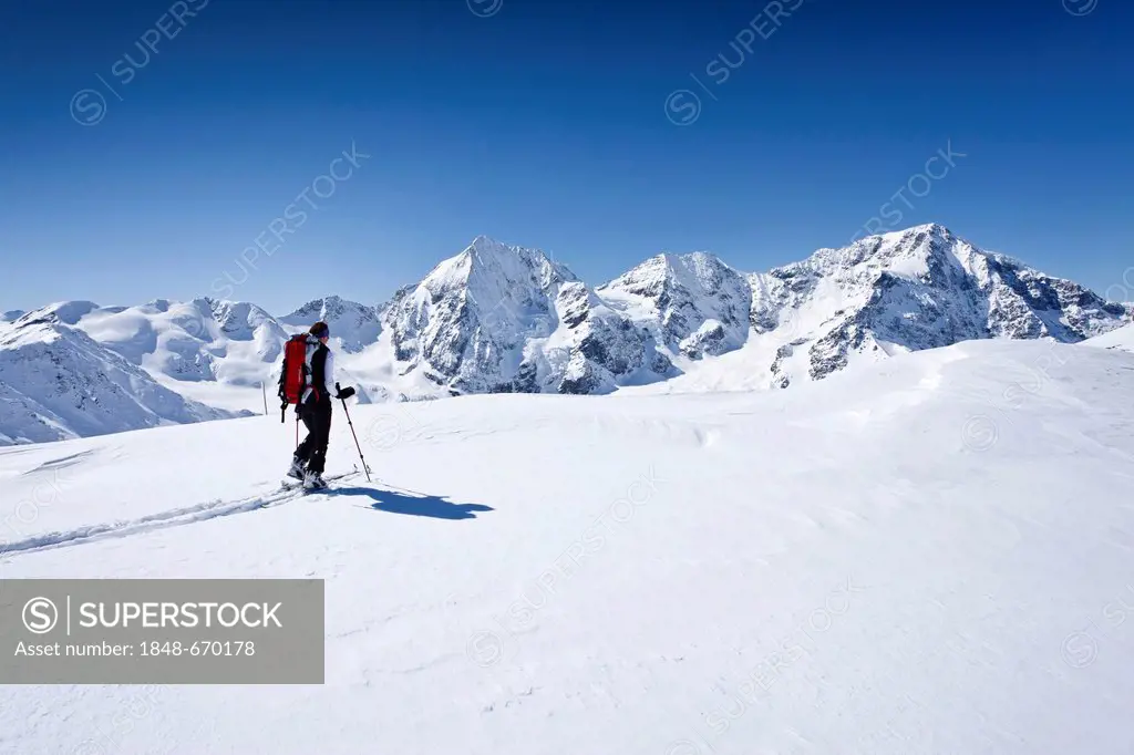 Ski touring, ascending to Mt. Hintere Schoentaufspitze, Solda in winter, behind the Koenigsspitze peak, Mt. Ortler and Mt. Zebru, South Tyrol, Italy, ...