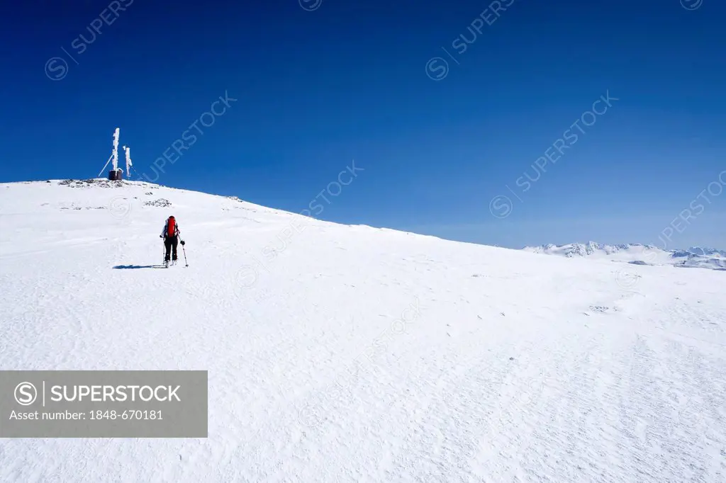 Ski touring, ascending to Mt. Hintere Schoentaufspitze, Solda in winter, behind the Schoentaufspitze peak with the wather station, South Tyrol, Italy,...