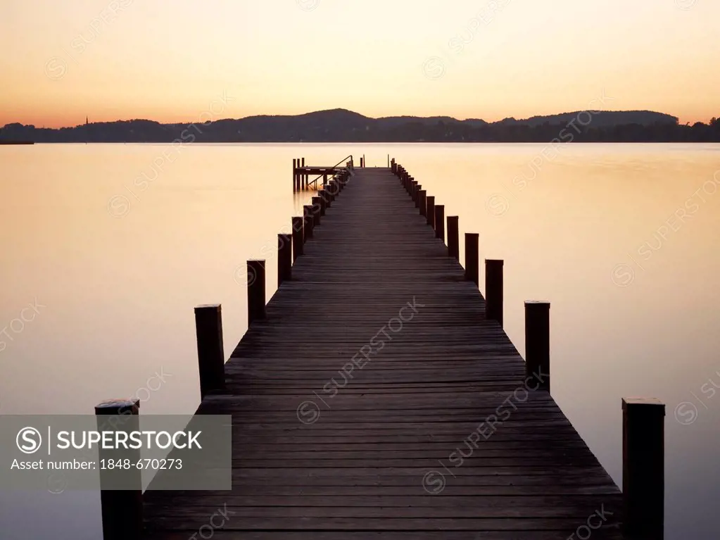 Pier in Lake Woerthsee at sunrise, Bavaria, Germany, Europe