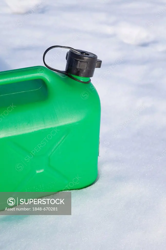 Green petrol canister in the snow, winter, energy consumption