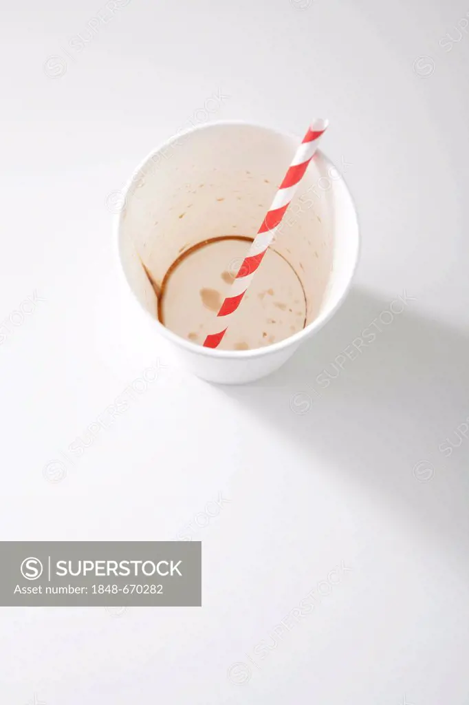 Empty paper cup with a straw