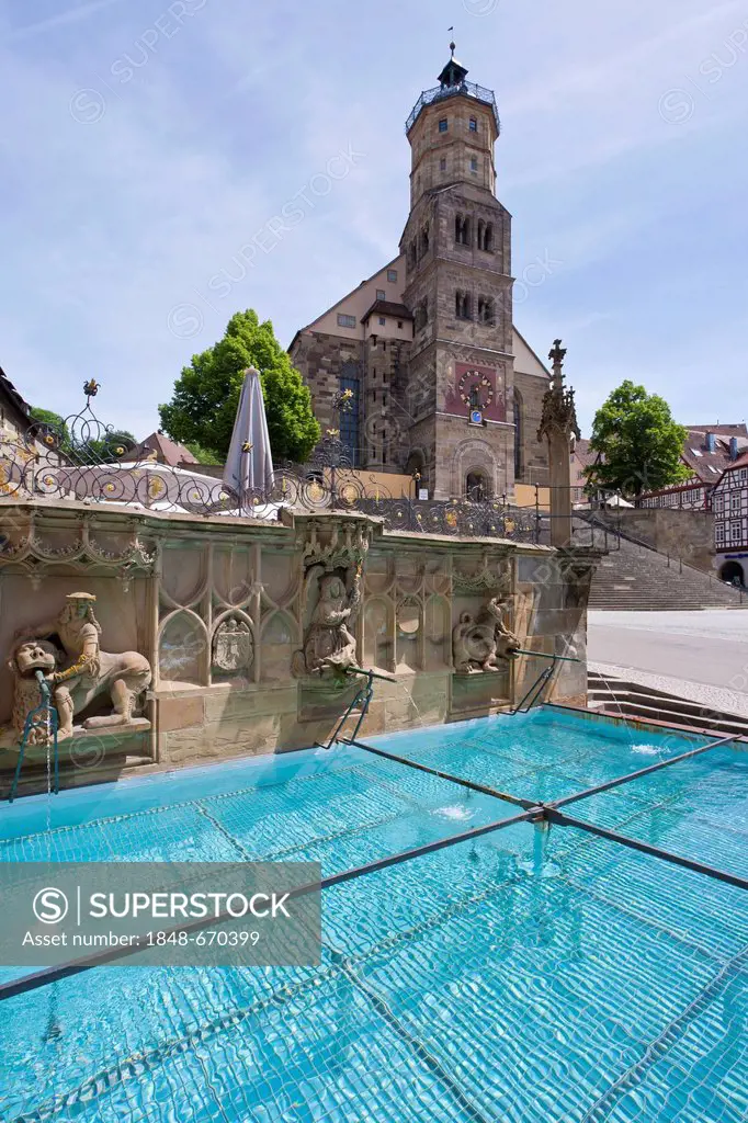 The Gothic Fischbrunnen fountain on Marktplatz square, Church of St. Michael, historic district of Schwaebisch Hall, Baden-Wuerttemberg, Germany, Euro...