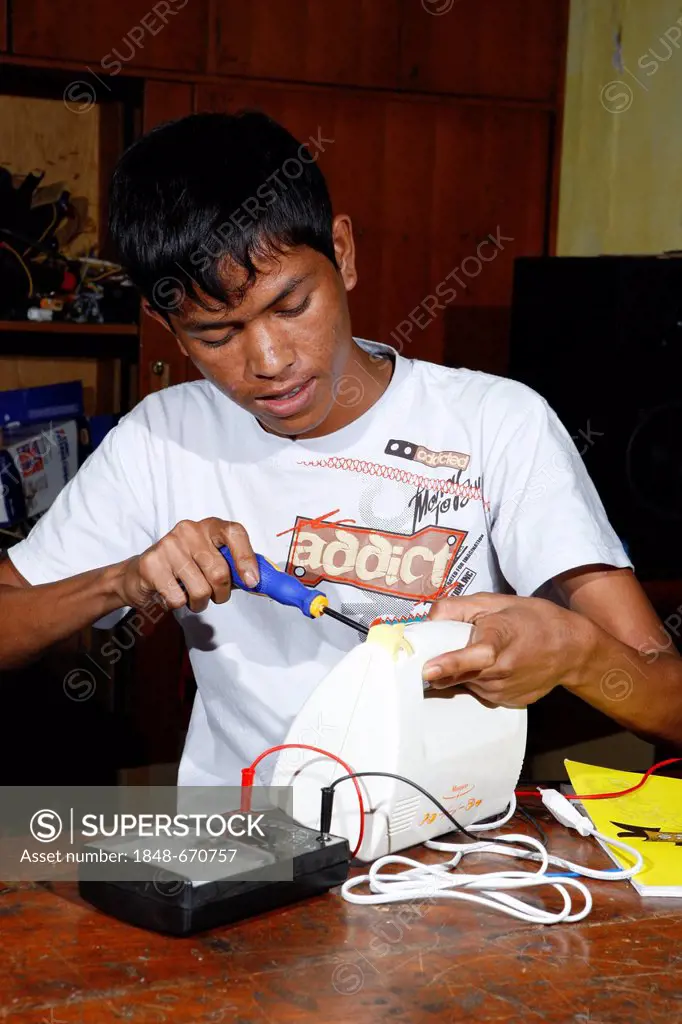 Teenager being trained as electrical engineer, Sukabumi, Bandung, Java, Indonesia, Southeast Asia