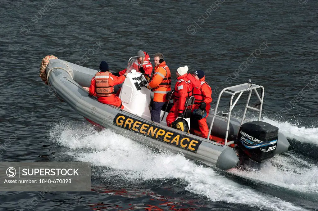 Greenpeace activists in an inflatable boat
