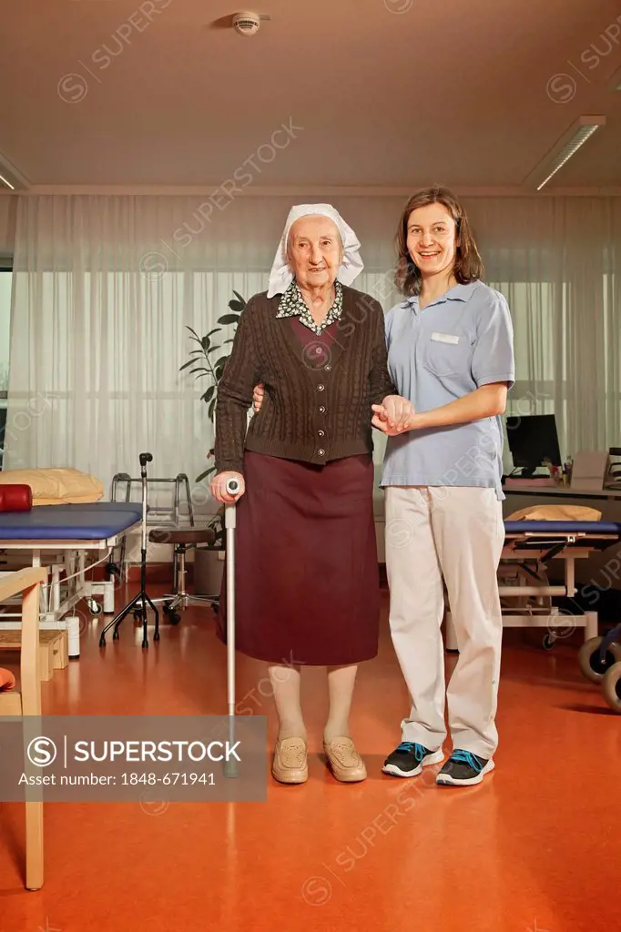 Old woman with a physiotherapist