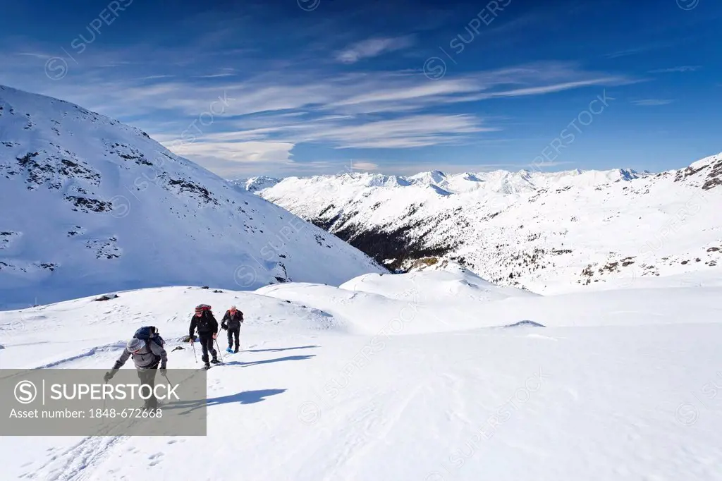 Snowshoers climbing Mt. Hoertlahner above Durnholz, behind the Sarntal Valley and its mountains, Sarntal, South Tyrol, Italy, Europe