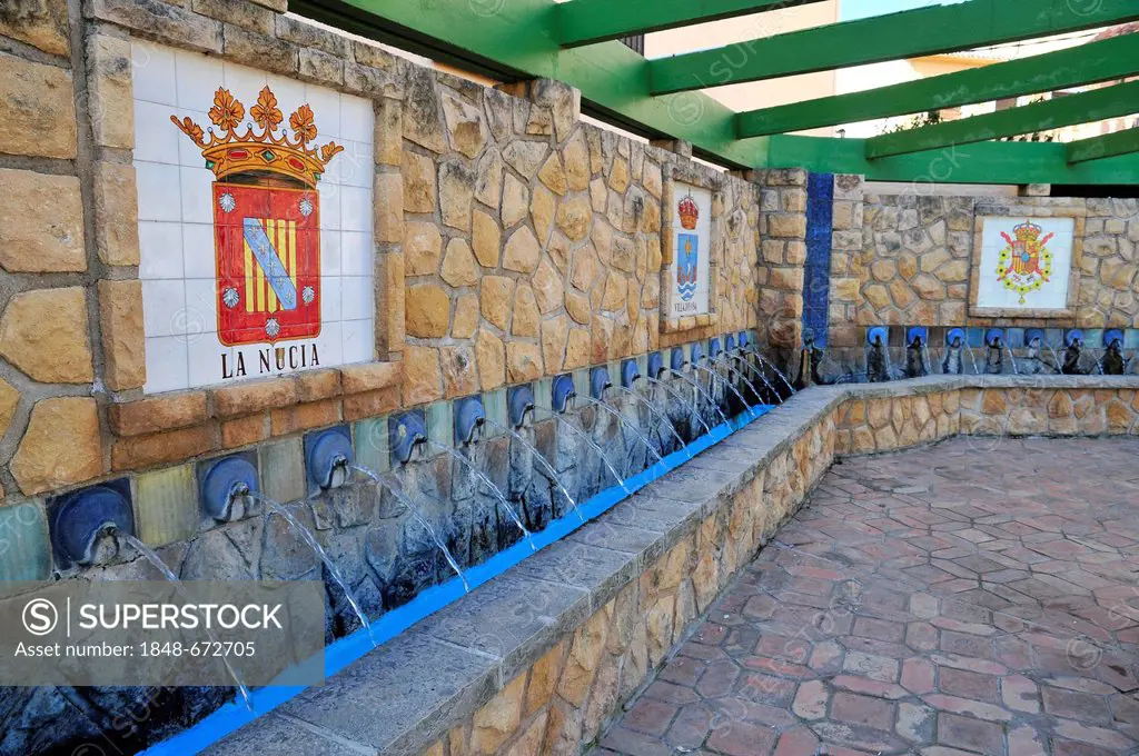 Fountain with coat of arms of the surrounding towns, here La Nucia, mountain village of Polop de la Marina, Costa Blanca, Spain, Europe