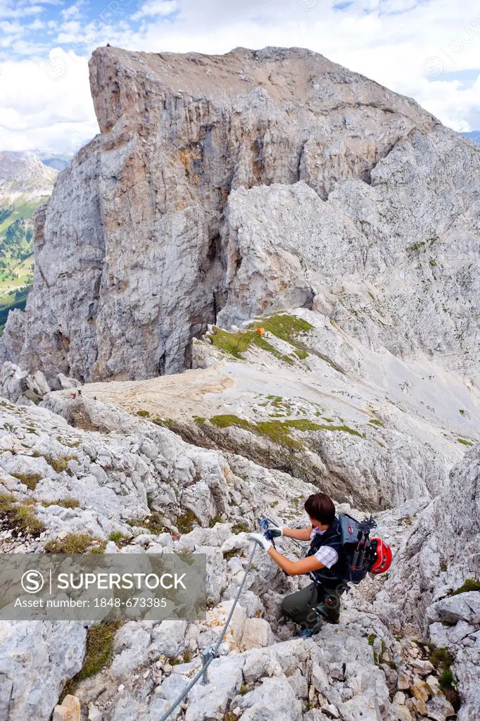 Hiker on the Latemar crossing, fixed rope route, Dolomites mountain range, South Tyrol, Italy, Europe