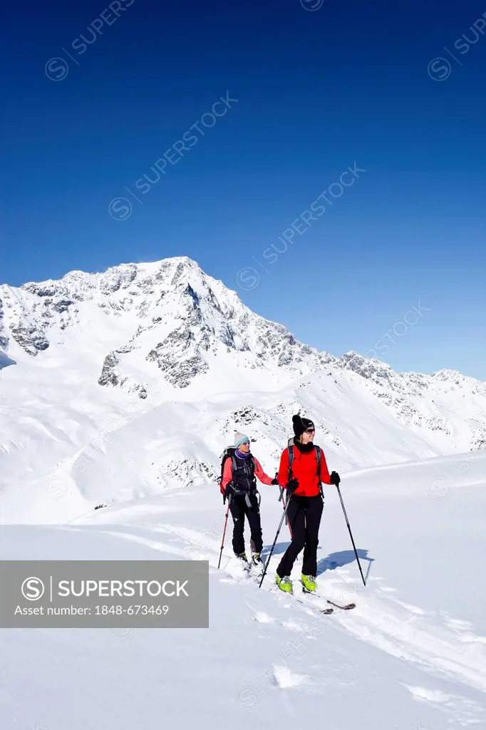 Ski touring, ascending to Mt. Hintere Schoentaufspitze, Solda in winter, behind Mt. Ortler, South Tyrol, Italy, Europe