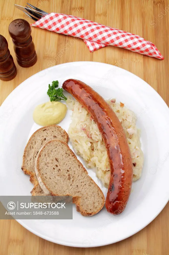 Krakowska smoked spicy Polish sausage on sauerkraut, crusty bread and mustard