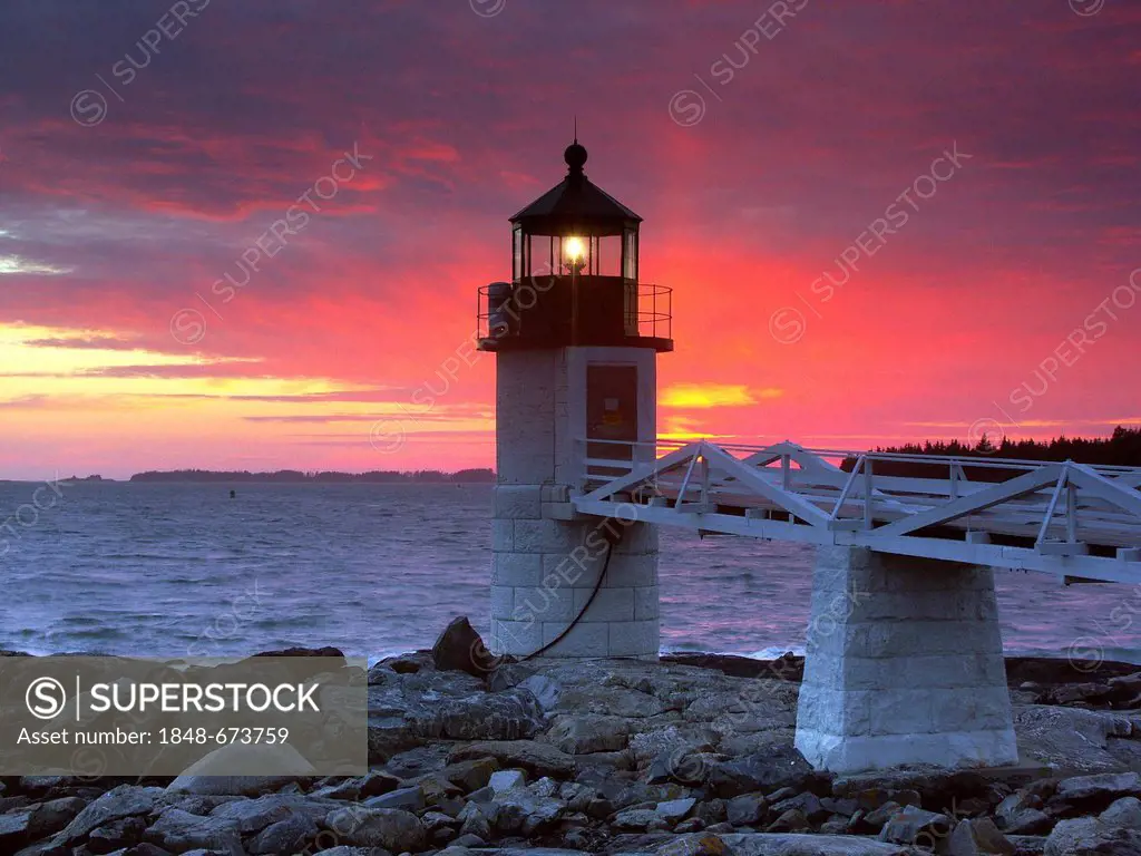 Spectacular sunset behind Marshall Point Lighthouse in Port Clyde, Maine, USA