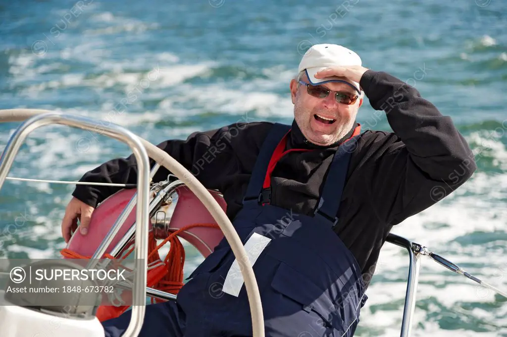 Skipper sitting at the stern of a yacht