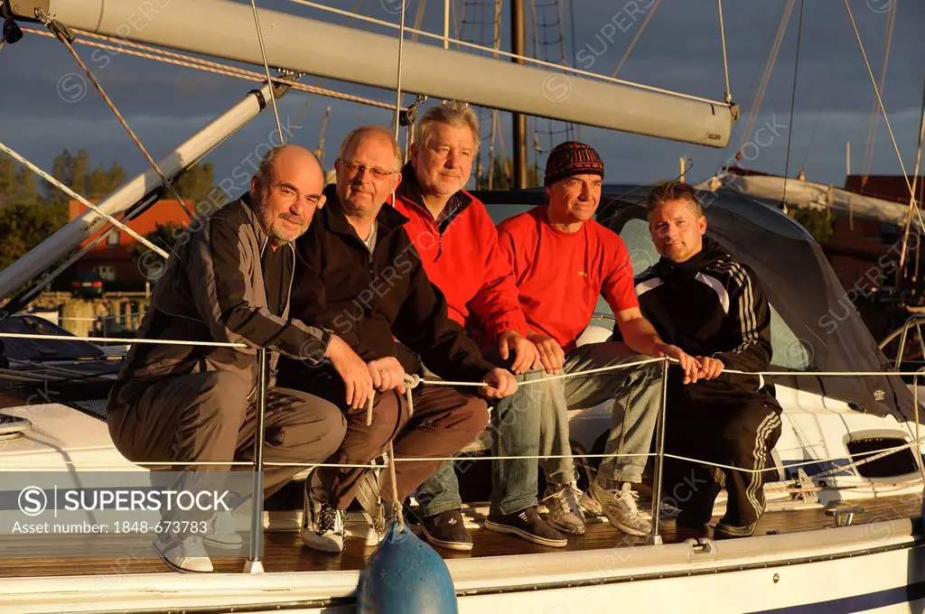 Crew of a sailing yacht on the upper deck in the morning sun