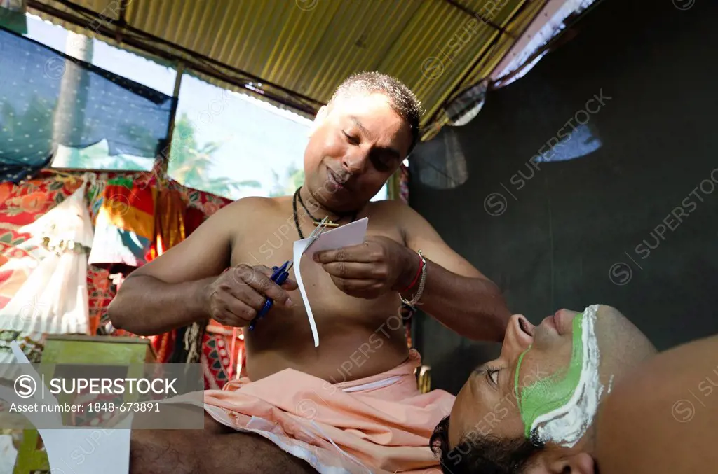 The make-up of the Kathakali character Jayantha is being applied, Varkala, Kerala, India, Asia