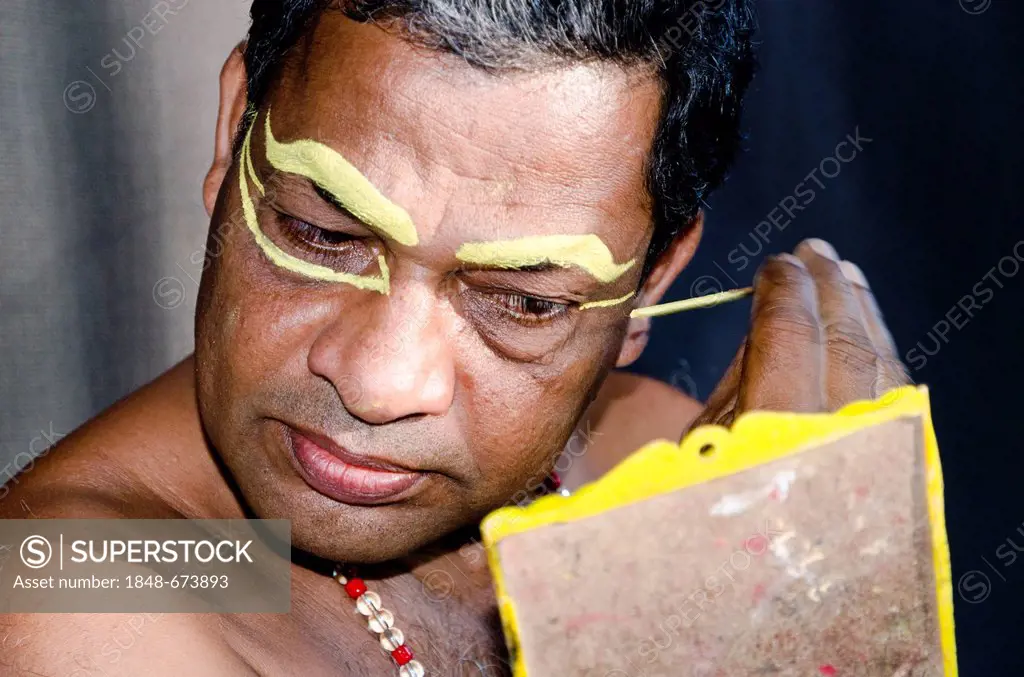 The make-up of the Kathakali character Nakrathundi is being applied, Varkala, Kerala, India, Asia