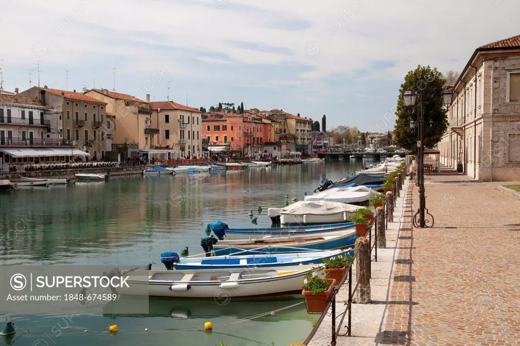 Boats in the canal in the historic centre of Peschiera, Lake Garda, Veneto, Italy, Europe, PublicGround