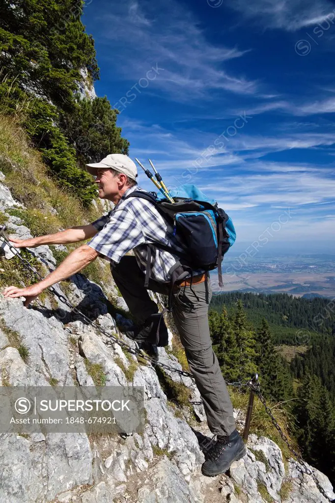 Man, 55, on a climbing route of Ettaler Manndl Mountain, a sub-peak of Laberberg Mountain in the Ammergau Alps, Ettal, Upper Bavaria, Bavaria, Germany...