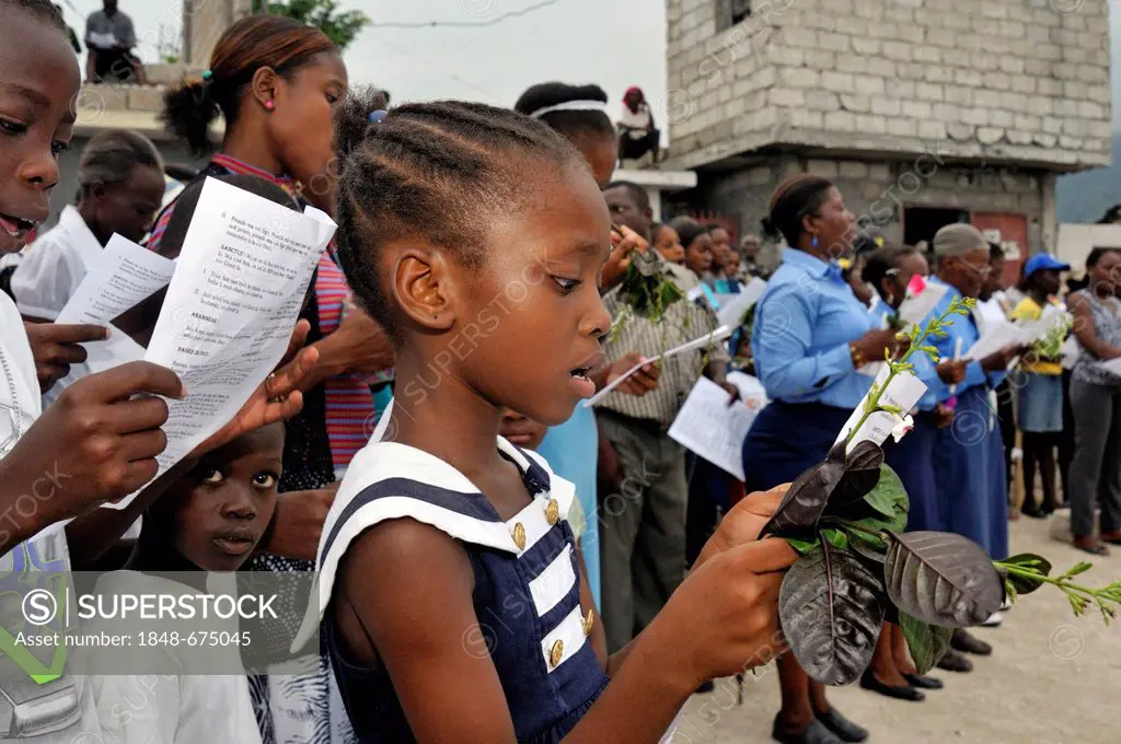 Girl singing during a church service in memory of the victims of the earthquake in January 2010, Fort National district, Port-au-Prince, Haiti, Caribb...