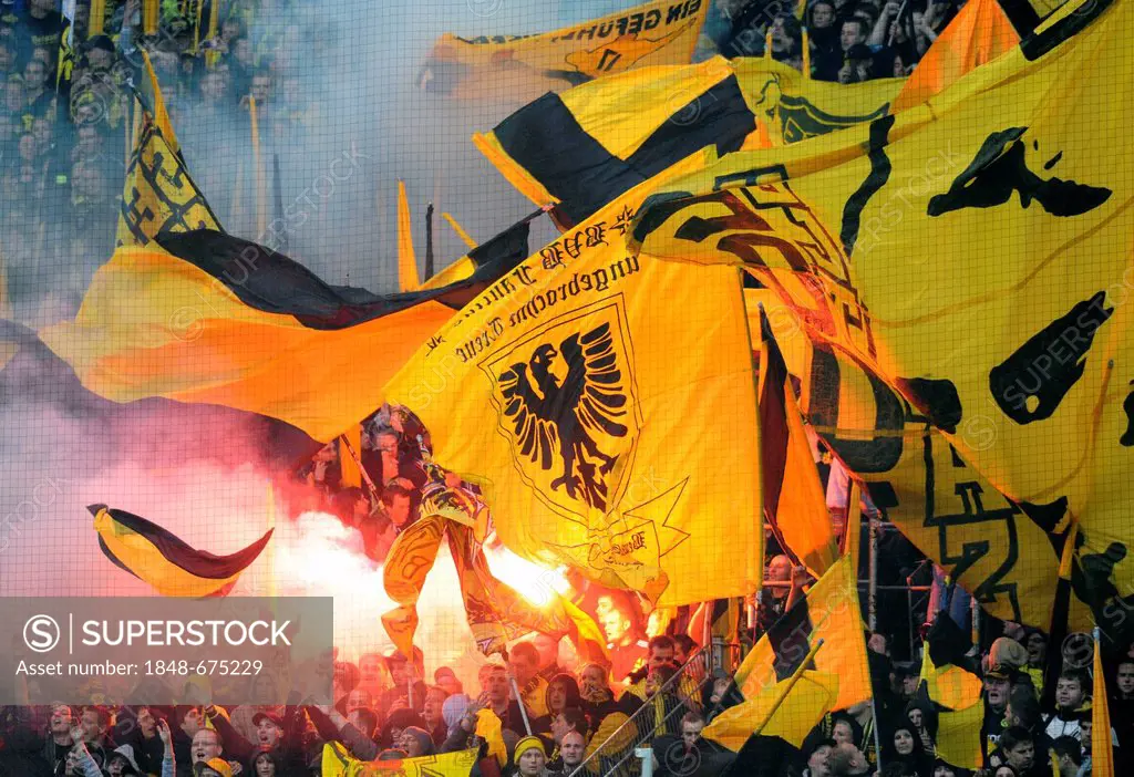 Fans of the football club BVB Borussia Dortmund on the south stand with flags and bengal flares during match Borussia Dortmund vs SC Freiburg (4:0), S...