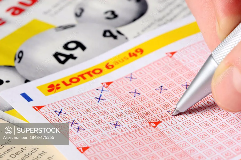 Person filling out a lottery ticket, 6 from 49, ticking off numbers